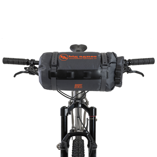 Bicycle handlebar with a black bag and visible branding on a white background