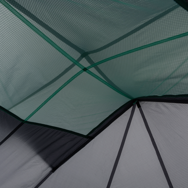 Close-up of overlapping translucent Pitchpine VST 1.5 fabric panels by Big Agnes Canada in green and gray, featuring stitched lines and geometric shapes that create an abstract, ultralight tent-inspired pattern.