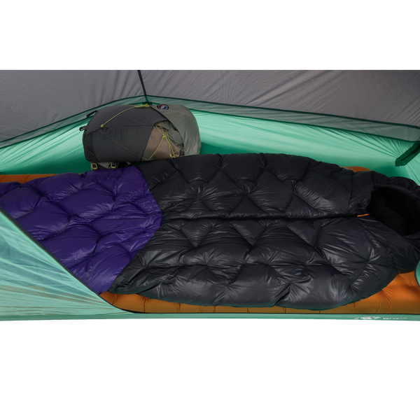 Two sleeping bags, one black and one with a purple section, are laid side by side inside the Big Agnes Canada Pitchpine VST 1.5 ultralight tent, with a backpack at the head—an inviting, durable shelter for your adventure.