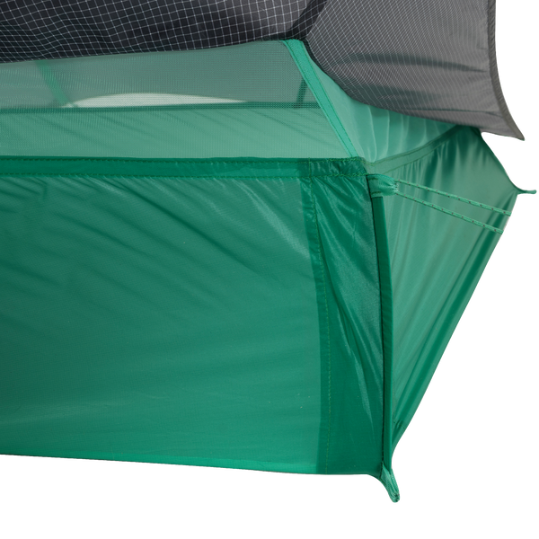 Close-up of the corner of the Big Agnes String Ridge VST 1.5 tent, an ultralight shelter featuring mesh upper panels, solid green lower fabric, and precise stitching that showcases its quality construction.