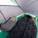 A sleeping bag and gray backpack are inside a light green Big Agnes String Ridge VST 1.5 tent. Its mesh roof and sides are visible, with a sleeping pad beneath the bag—making this ultralight tent perfect for outdoor adventures.