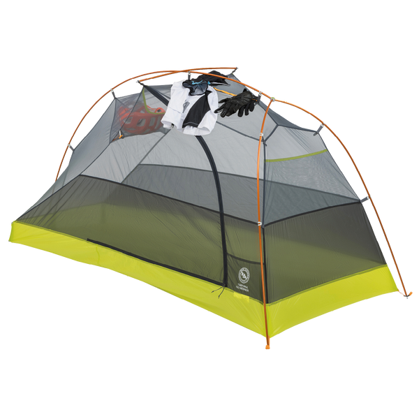 Tiger Wall UL1 Bikepack camping tent with a white shirt, black pants, and red shoes hanging inside on a white background
