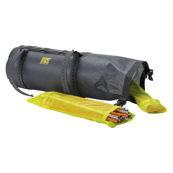 Gray roll-up Tiger Wall UL2 Bikepack dry bag stuff sack with a yellow drawstring bag containing items on a white background