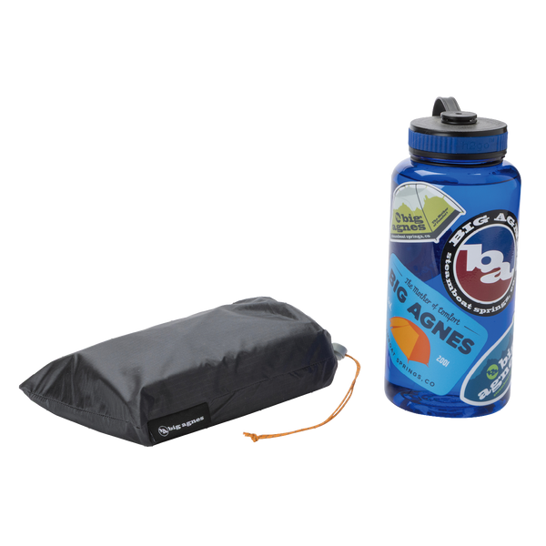 A blue water bottle with colorful Big Agnes stickers sits next to a compact, black Big Agnes Canada Tiger Wall UL1 Bikepack Footprint pouch featuring an orange drawstring, both displayed on a white background.
